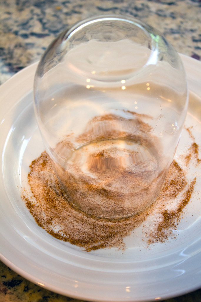 View of a cocktail glass upside down on plate with cayenne pepper and sea salt