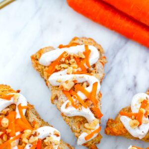 These Chai Carrot Cake Scones with cream cheese frosting combine everything you love about carrot cake into a perfectly spiced treat that's delicious for dessert or breakfast!