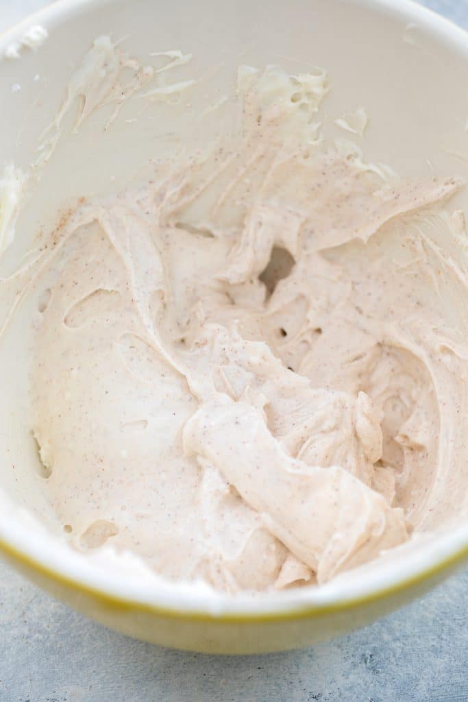 Overhead view of a bowl filled with chai cream cheese frosting