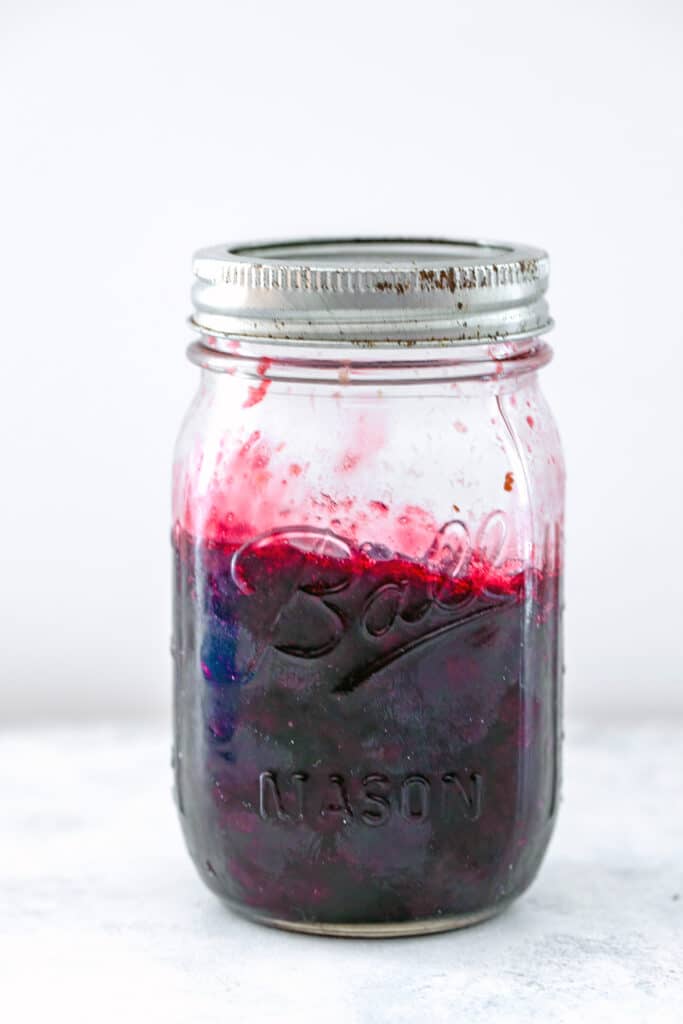 Head-on view of a mason jar of cherry lime jam