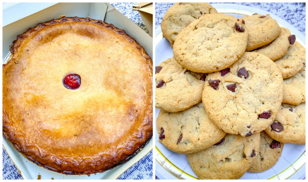 Cherry pie in box and chocolate chip cookies on plate.