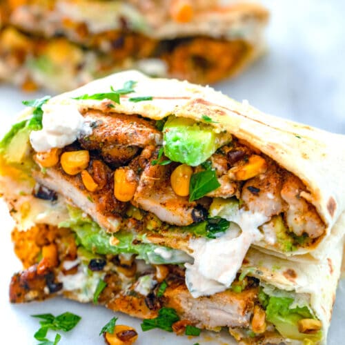 These Chicken, Avocado, and Corn Burritos are topped with feta sauce and make for a fresh and flavorful weeknight dinner that's incredibly quick and easy!