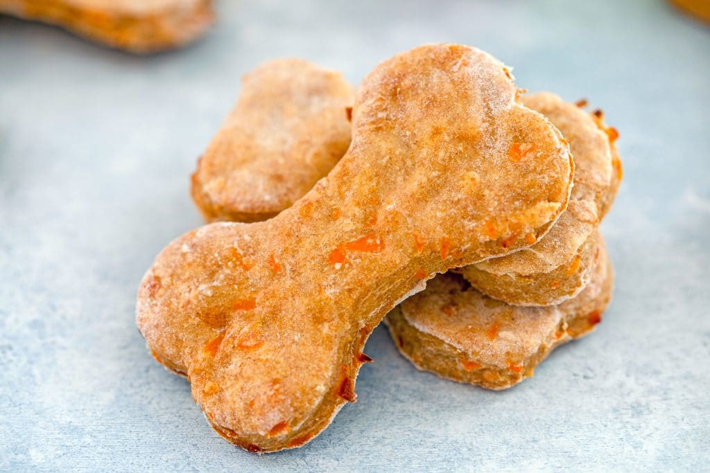 Landscape photo of three homemade chicken dog treats stacked on each other