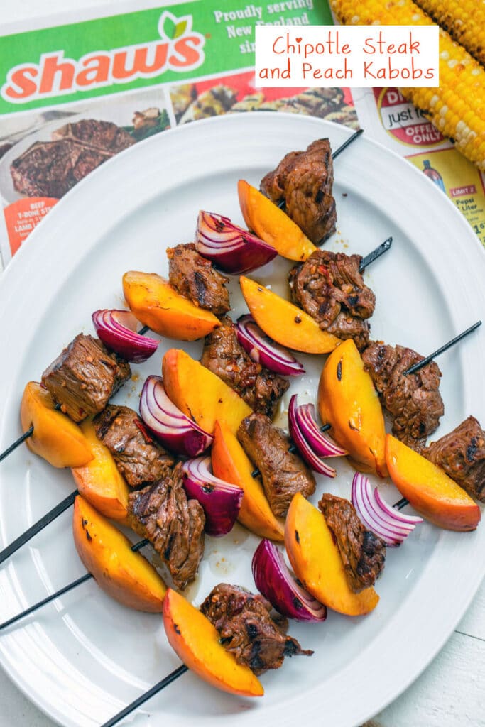 Overhead view of marinated steak, sliced peaches, and chopped onion on kabobs on a platter with corn on the side and Shaw's circular