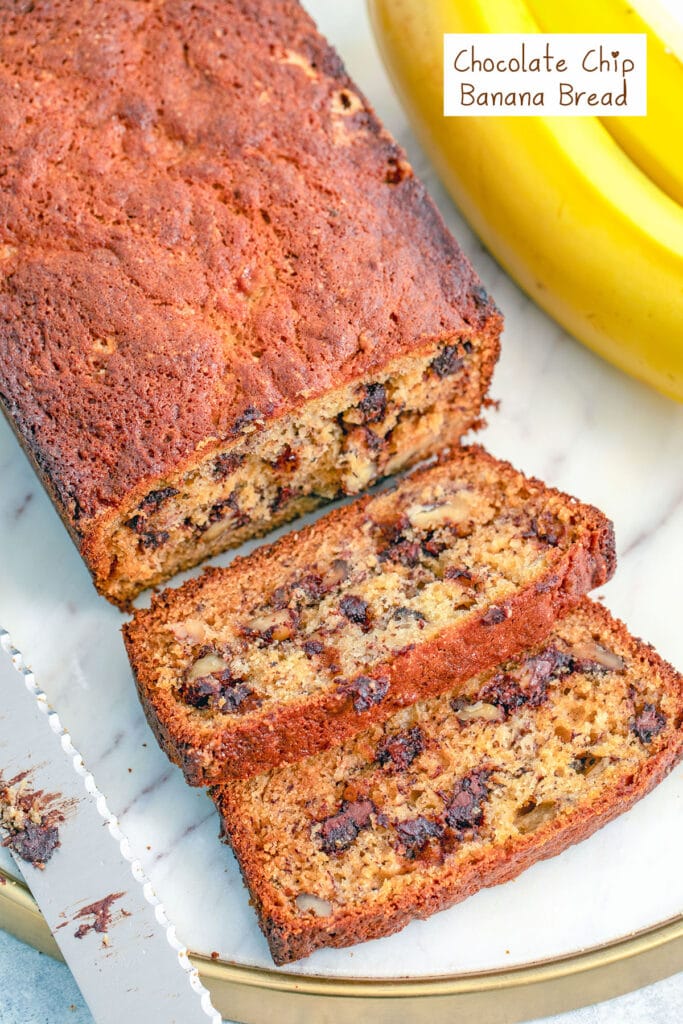 Overhead closeup view of a loaf of chocolate chip banana bread with a couple slices cut a knife and bananas in the background with recipe title at top.