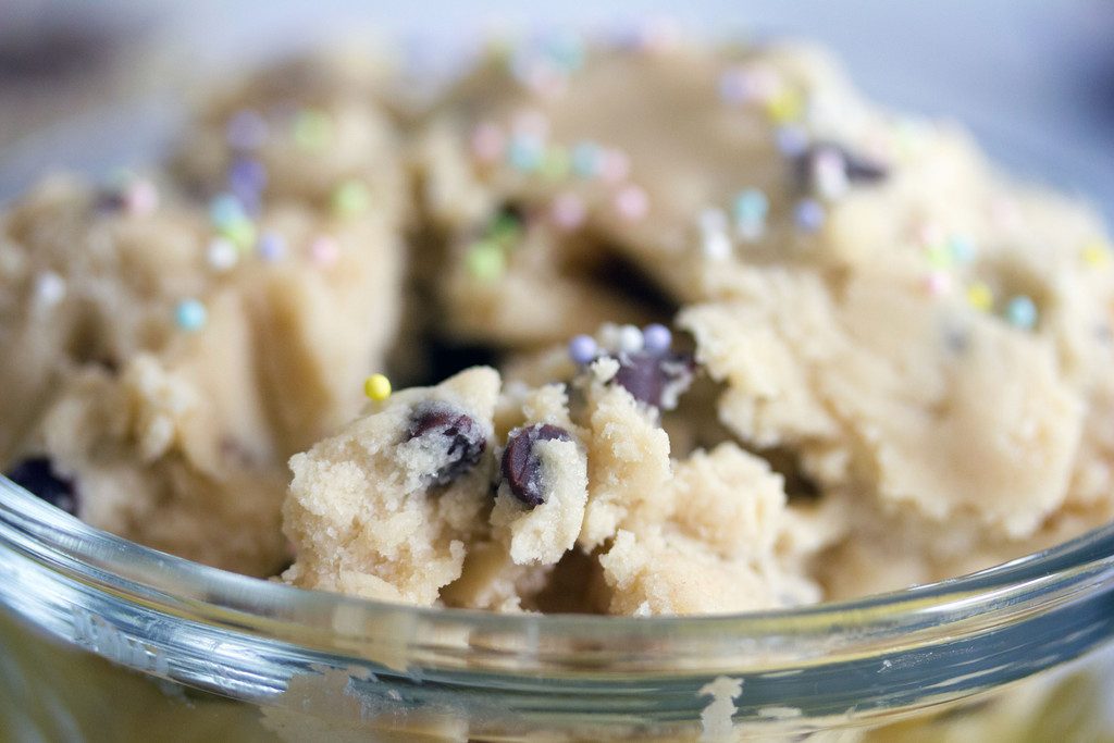 Head-on closeup view of chocolate chip cookie dough with sprinkles