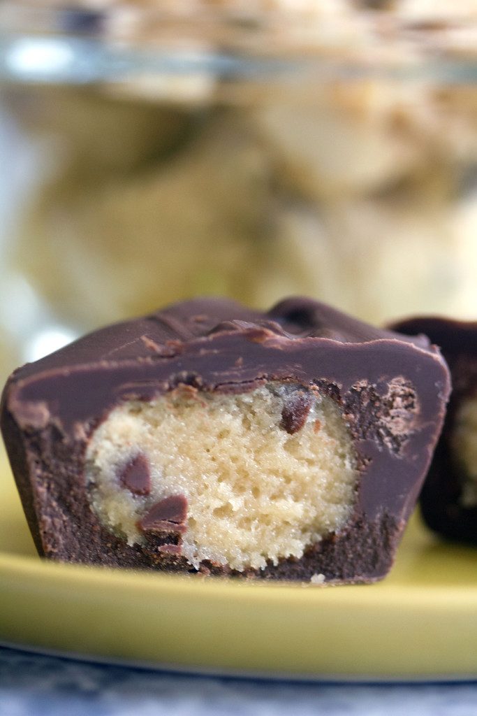 Head-on closeup view of half of a chocolate-covered chocolate chip cookie dough cup showing cookie dough inside