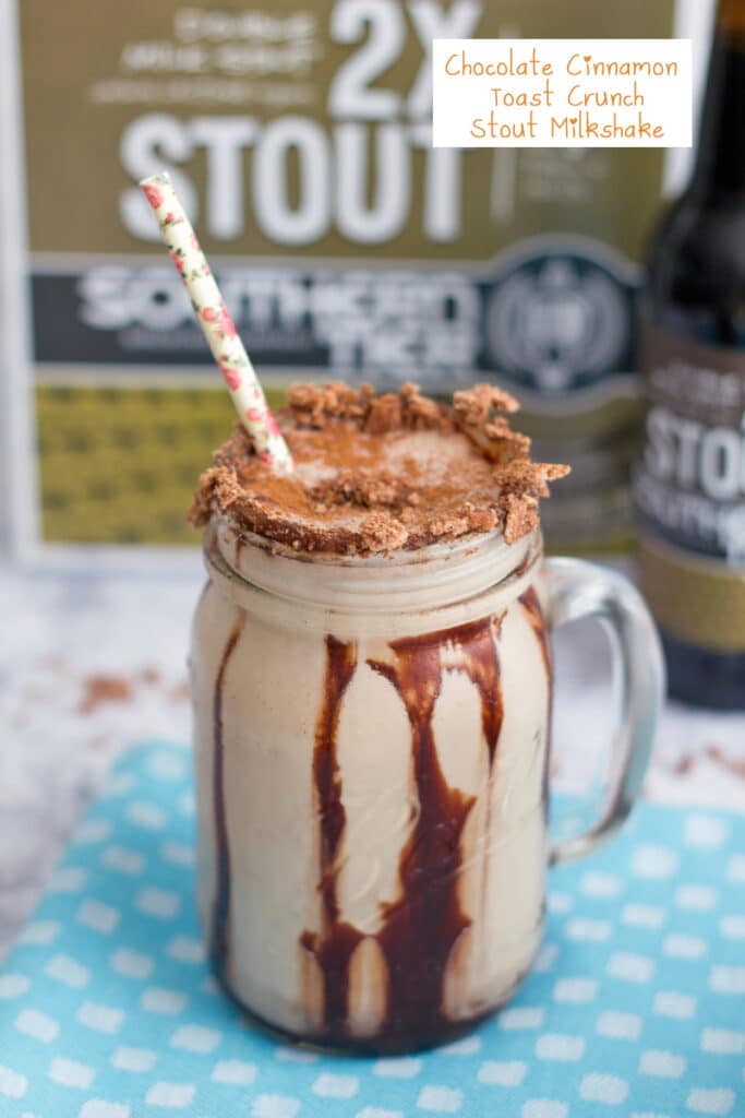 Head-on view of a Chocolate Cinnamon Toast Crunch stout  milkshake in a mason jar with chocolate syrup drizzle, cereal rim, and straw with beer in the background with recipe title at top
