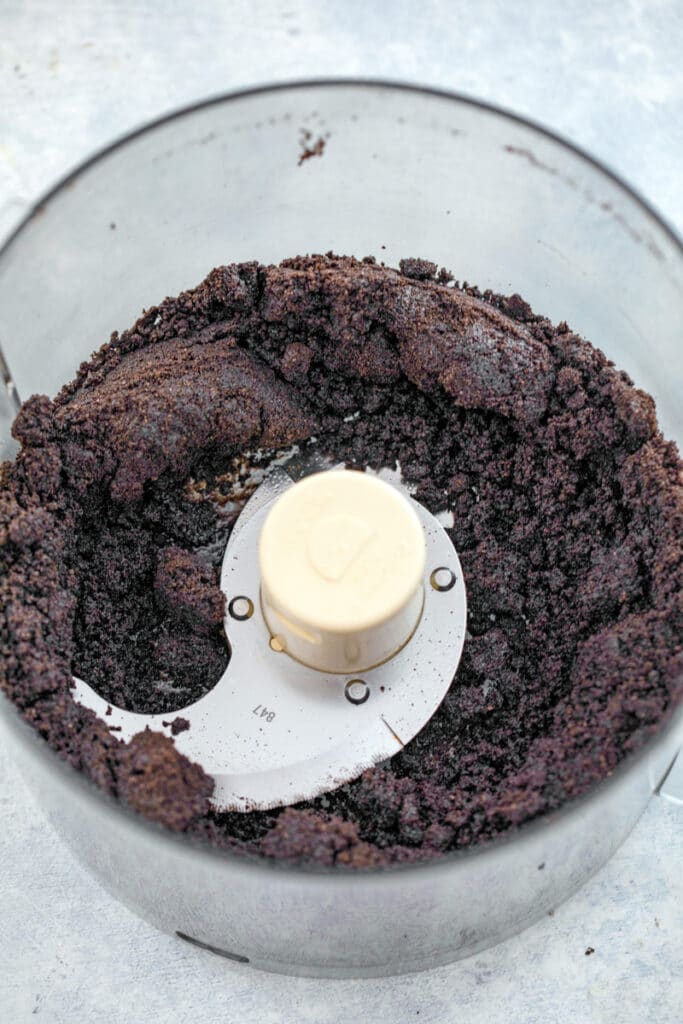 Overhead view of Oreo cookie crumbs in food processor