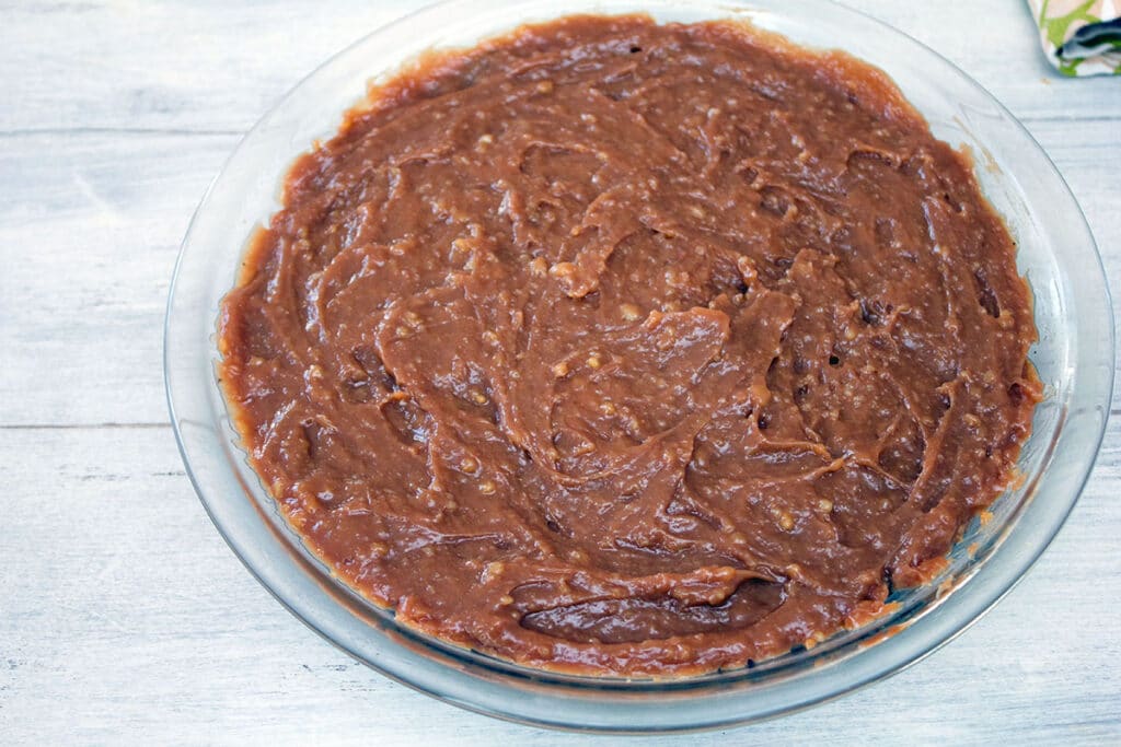 Overhead view of pie plate filled with chocolate cream filling.