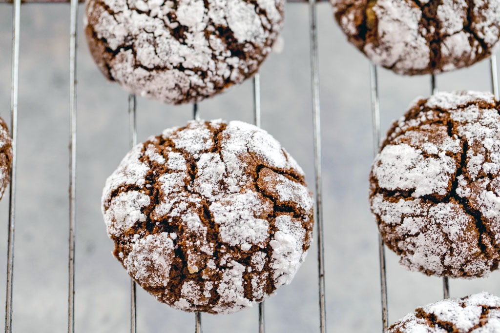 Overhead view of chocolate peppermint sour cream crinkle cookies just out of the oven and cooling on a baking rack