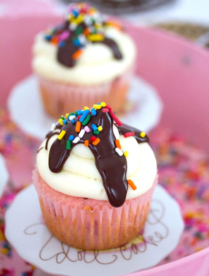 Chocolate, Vanilla, and Strawberry Cupcakes -- These Chocolate, Vanilla, and Strawberry Cupcakes take the classic flavors of ice cream and turn them into ice cream sundae cupcakes with strawberry cake, chocolate ganache filling, and vanilla buttercream. Topped with more chocolate and sprinkles, of course! | wearenotmartha.com