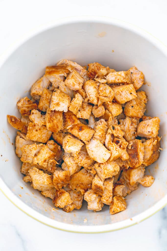 Diced spiced chicken in a bowl.