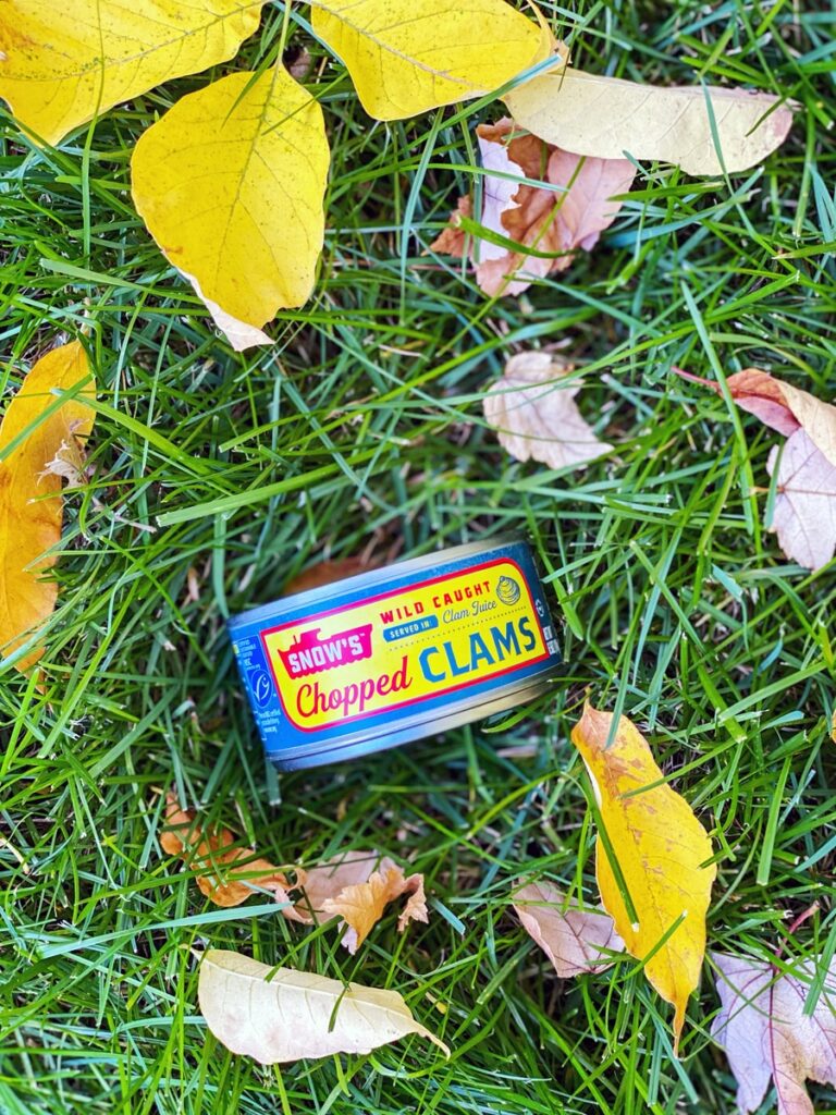 Can of chopped clams in the grass