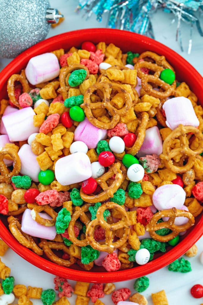 Overhead close-up view of Christmas trail mix in a red bowl