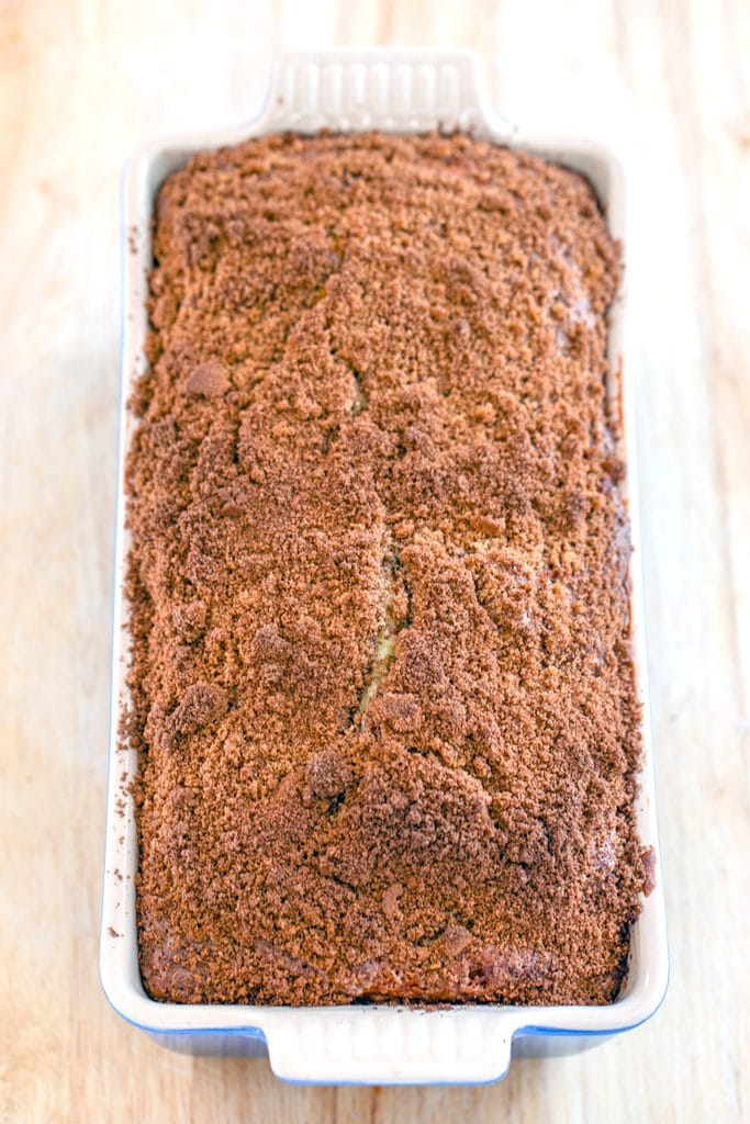 Overhead view of cinnamon loaf cake in loaf pan just out of the oven