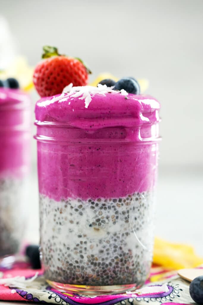 Head-on closeup view of a coconut chia dragon fruit smoothie jar 