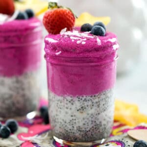 Head-on closeup view of coconut chia dragon fruit smoothie jar with second in background