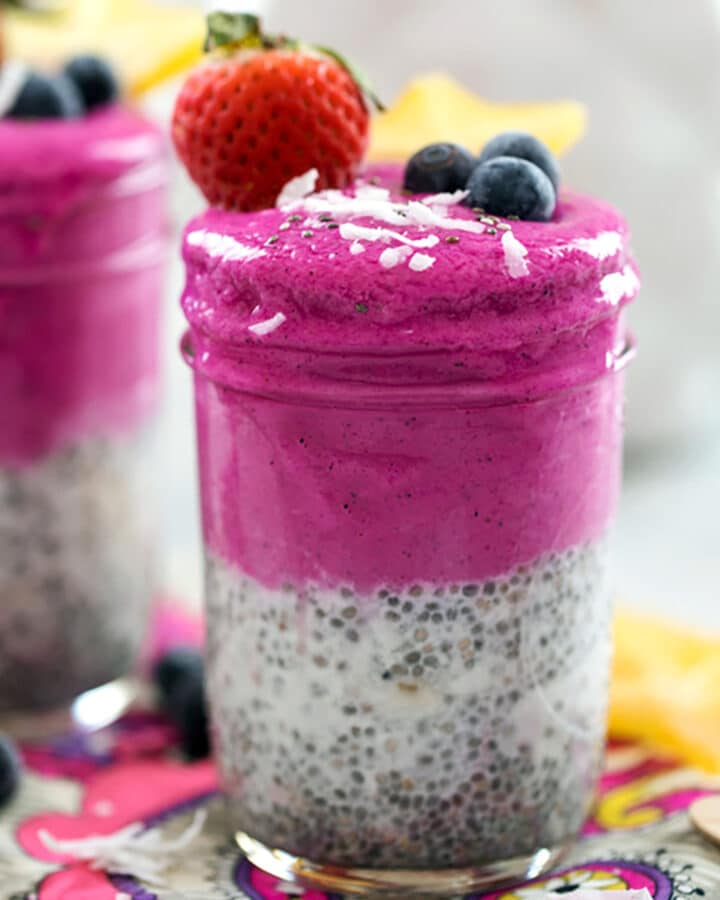 Head-on closeup view of coconut chia dragon fruit smoothie jar with second in background