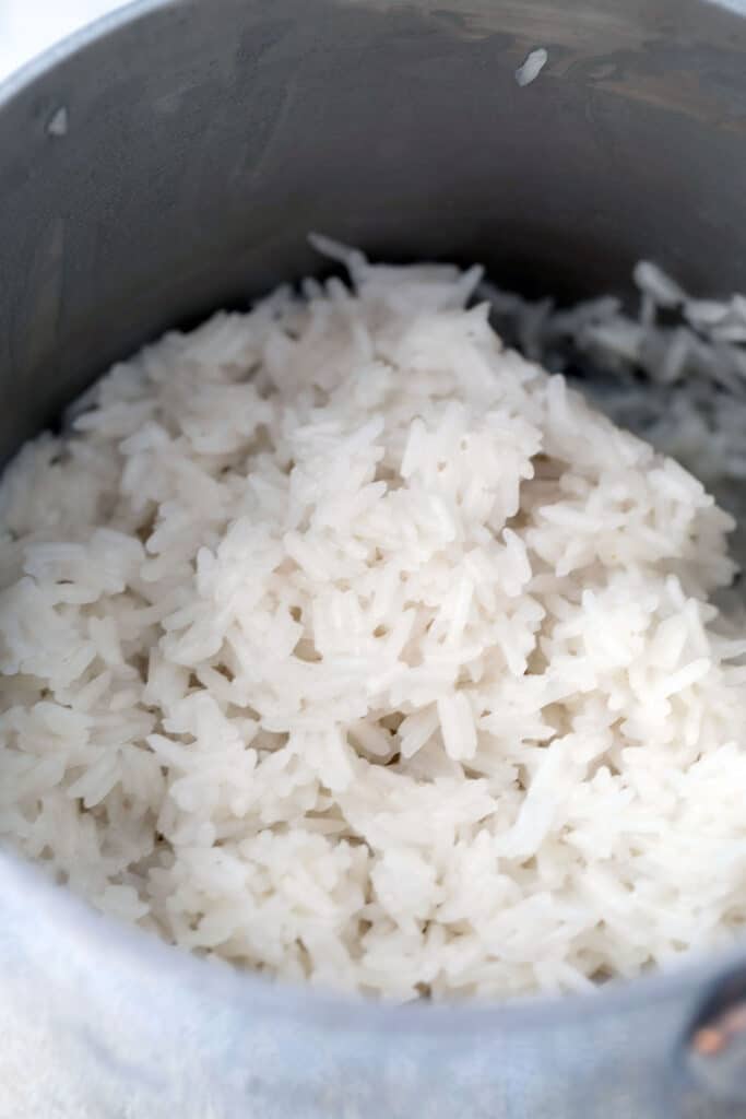 Fluffy cooked coconut rice in saucepan.