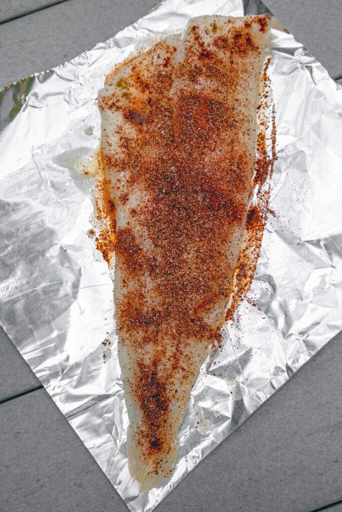 Overhead view of piece of cod coated in spices