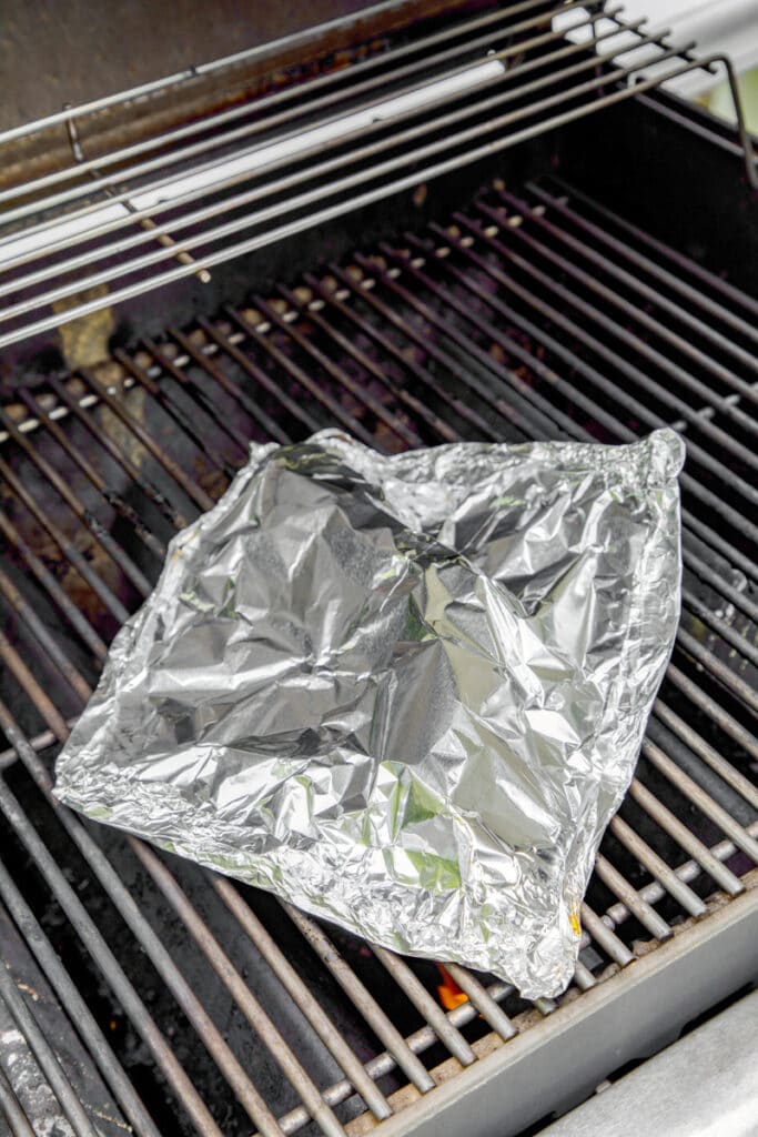 Cod wrapped in foil on grill