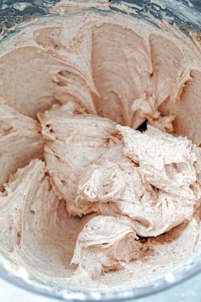 Overhead view of cinnamon buttercream frosting in mixing bowl