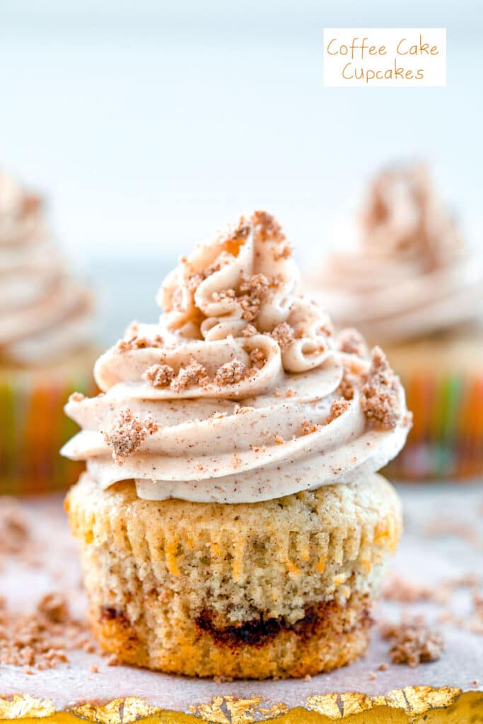 Head-on close-up view of a coffee cake cupcake with cinnamon swirl, cinnamon frosting and crumb topping with recipe title at top