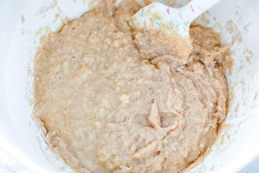 Overhead view of bowl of cupcake batter with spatula
