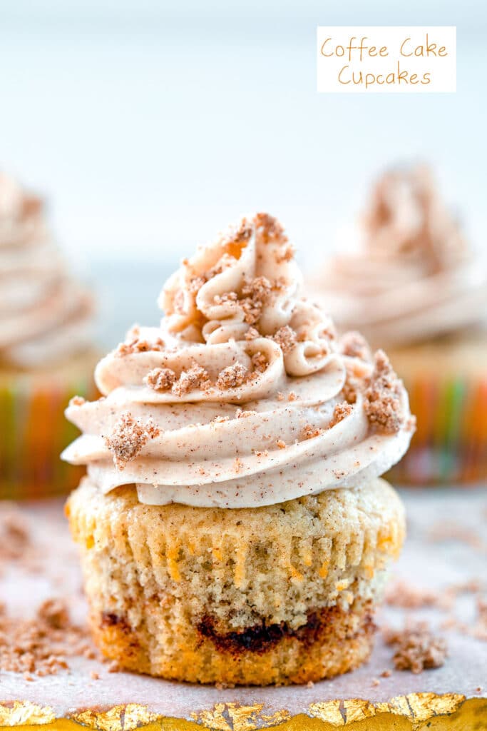 Head-on close-up view of a coffee cake cupcake with cinnamon swirl, cinnamon frosting and crumb topping with recipe title at top.