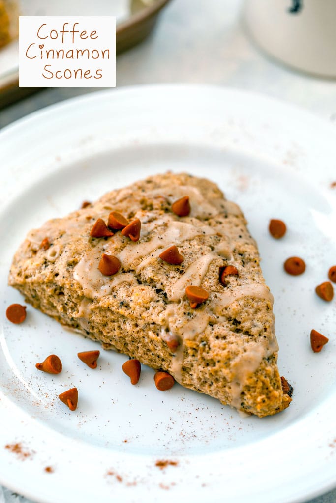 Close-up overhead view of a coffee cinnamon scone on a white plate with cinnamon chips scattered around and "Coffee Cinnamon Scones" text at top