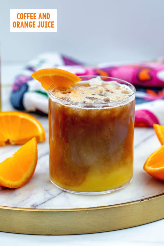Coffee and orange juice in a glass with orange slices all around and recipe title at top.