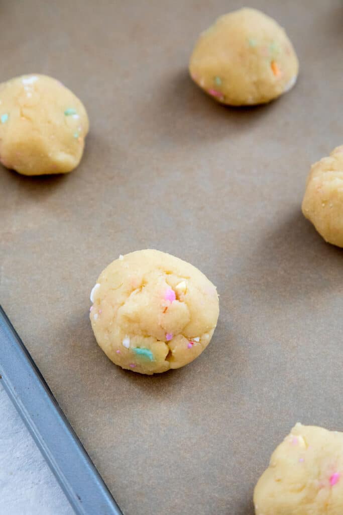 Conversation Heart Cookies rolled into balls on cookie sheet