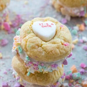 Conversation Heart Cookies with Marshmallow Fluff -- Put those conversation hearts to good use this Valentine's Day by baking Conversation Heart Cookies. Marshmallow fluff is sandwiched between two colorful candy confetti-packed sugar cookies and will instantly have you falling in love | wearenotmartha.com