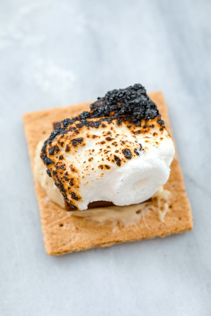 Overhead view of charred and roasted marshmallow on a cookie dough smeared graham cracker