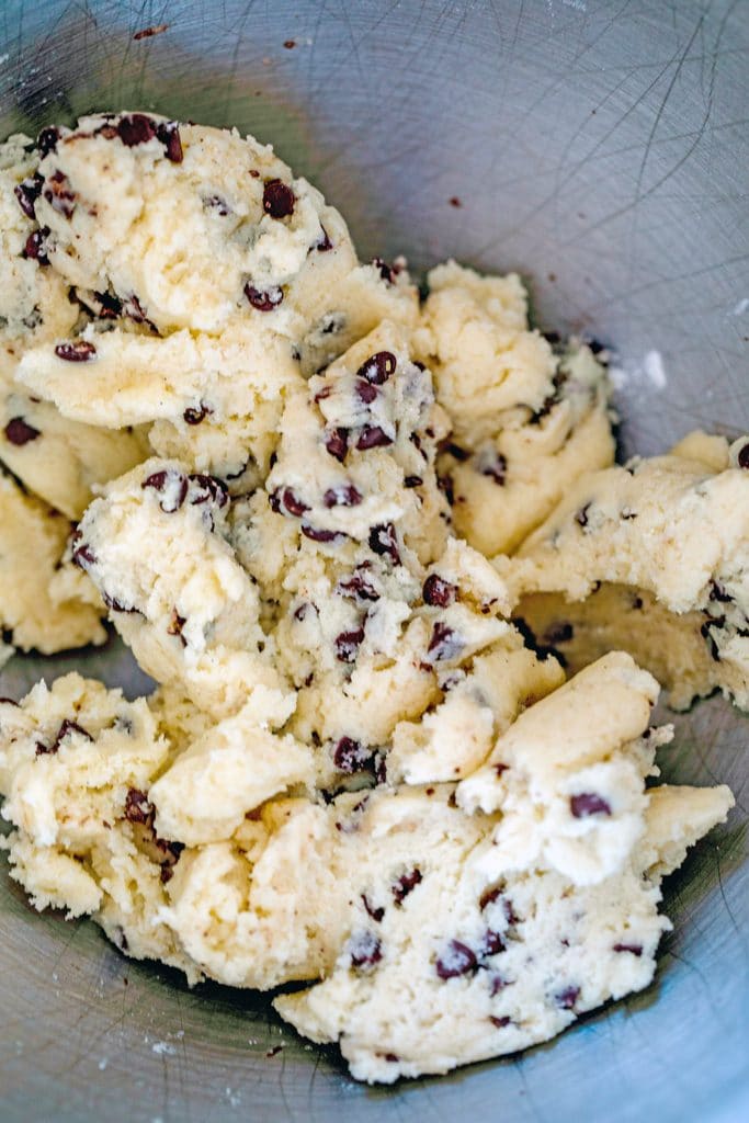 Overhead view of chocolate chip cookie dough in mixing bowl