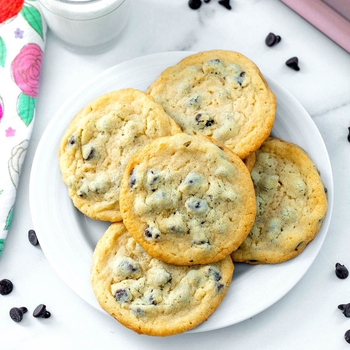 Overhead view of a plate of chocolate chip cookies with pancake mix with chocolate chips all around