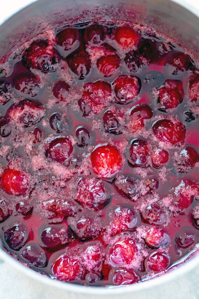 Fresh cranberries simmering in sugar water for syrup