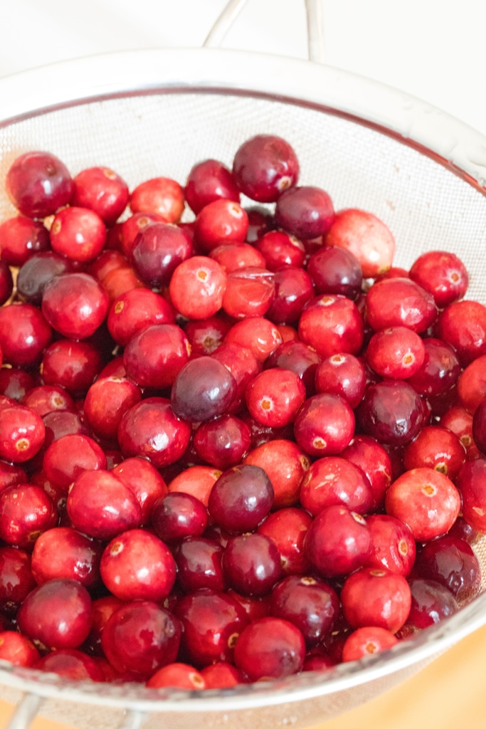 Overhead view of fresh cranberries in a strainer