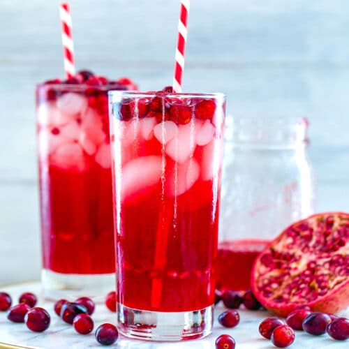 Cranberry Pomegranate Cocktail -- This Cranberry Pomegranate Sparkler is the holiday cocktail of your dreams. Made with cranberry simple syrup and pomegranate juice, it's perfectly sweet and festive. It's also delicious as a virgin cocktail | wearenotmartha.com