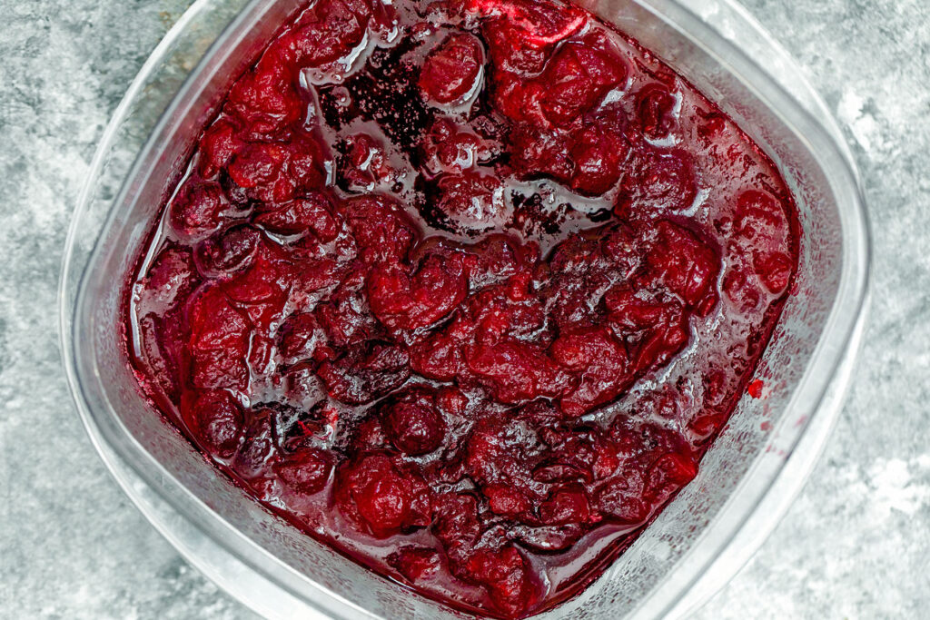 Homemade cranberry sauce in container