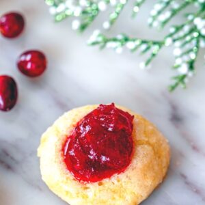 Cranberry Thumbprint Cookies -- These simple-to-make Cranberry Thumbprint Cookies are holiday cookies packed with festive flavor thanks to an orange shortbread crust and cranberry filling | wearenotmartha.com