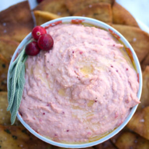 Cranberry Hummus with Sage Pita Chips -- This Cranberry Hummus is served with Sage Pita Chips and makes for the perfect holiday appetizer or solution to those Thanksgiving leftovers | wearenotmartha.com