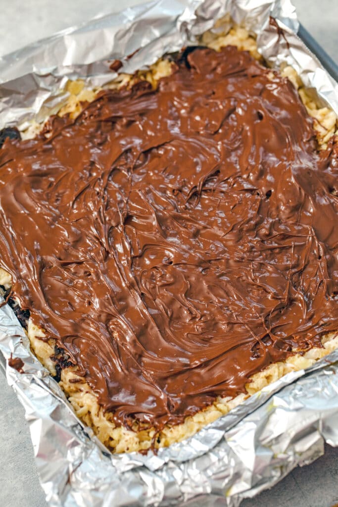 Overhead view of treats in pan with chocolate spread over the top