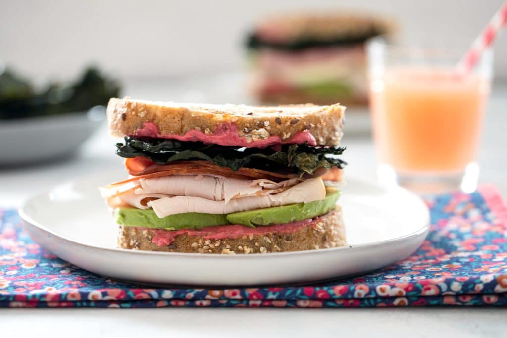 Crispy Kale Turkey and Ham Sandwiches with Beet Mayo -- These sandwiches contain all the components of a perfect sandwich: Great bread, a delicious spread, a little crunch, and really good natural deli meat | wearenotmartha.com