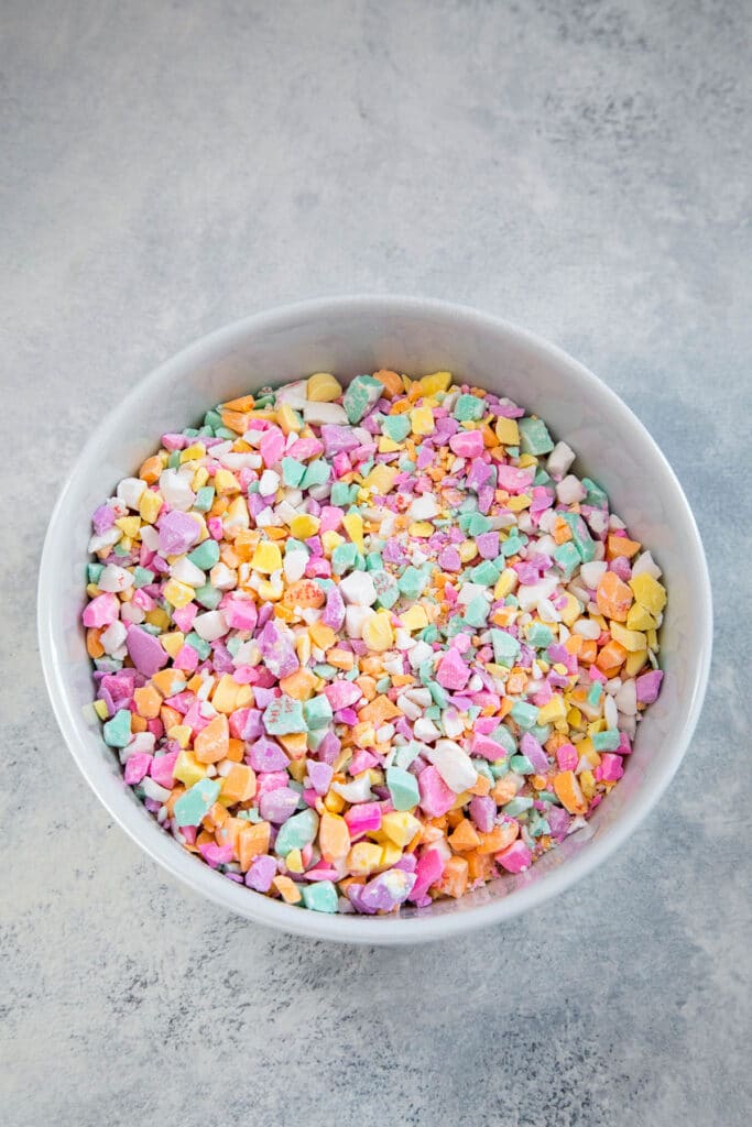 Conversation Hearts crushed in bowl.