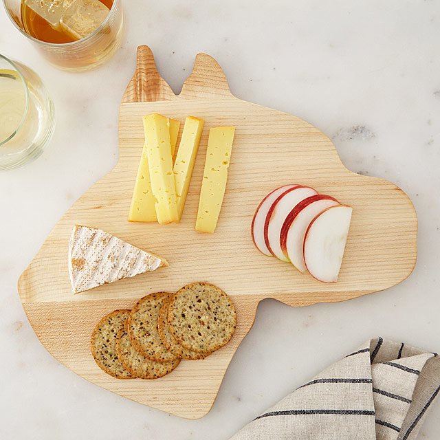 Dog shaped cheese board with snacks on it