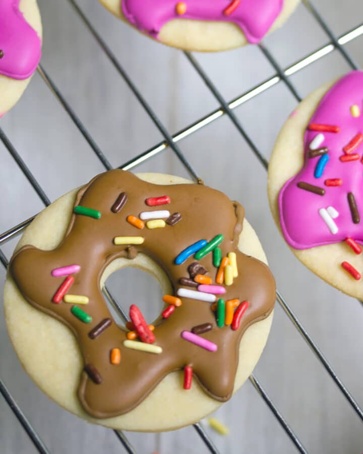 Doughnut Sugar Cookies -- Cookies or doughnuts? How could you possibly decide the better dessert? With these Doughnut Sugar Cookies, you don't have to! Serve your doughnuts up in sugar cookie form. They're easy to bake and decorate! | wearenotmartha.com #donuts #doughnuts #cookies #sugarcookies