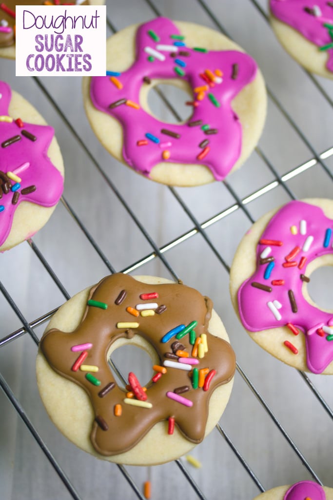 Overhead view of multiple doughnut sugar cookies with pink and brown frosting and sprinkles on baking rack with recipe title at top