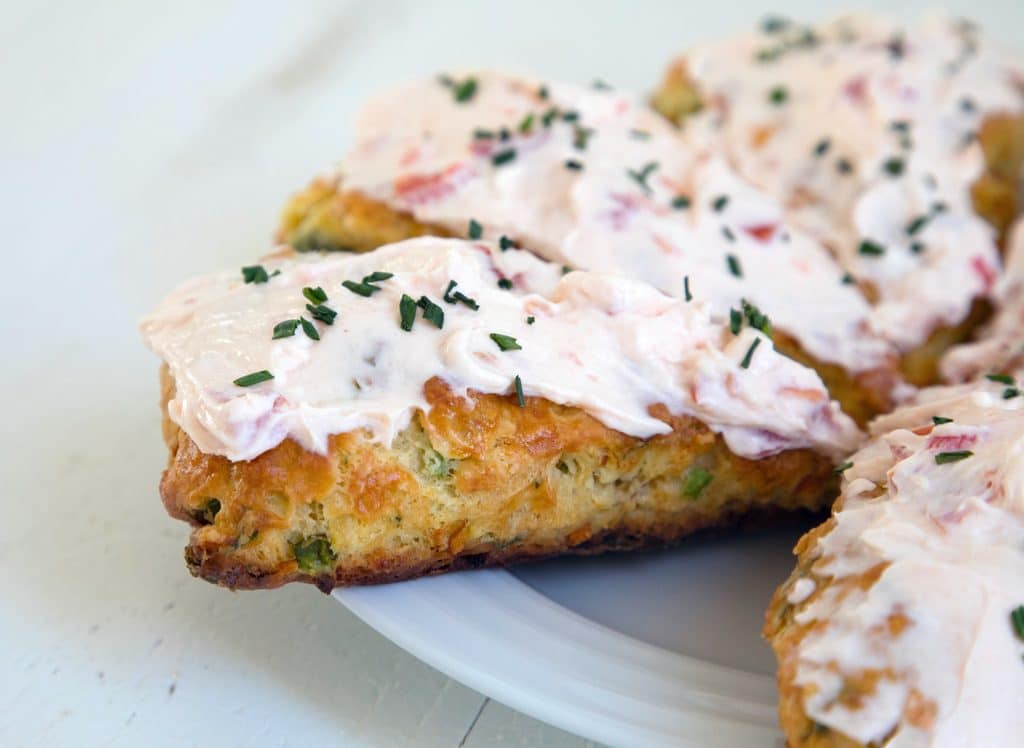 Eat Your Vegetables Savory Scones -- These Savory Scones can be made with any vegetables or cheese you need to use up in your fridge. This version uses carrots, kale, bell peppers, and feta with a savory tomato cream cheese icing as the perfect topping | wearenotmartha.com